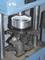 Machine for machining a cylindrical metal component, which is clamped between vertical supports. Industrial workshop environment.