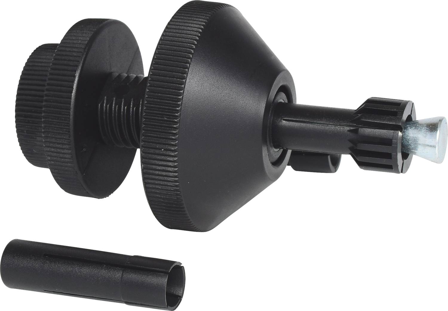 Black tool consisting of two round parts with a protruding handle. Beside it lies a small cylindrical object.