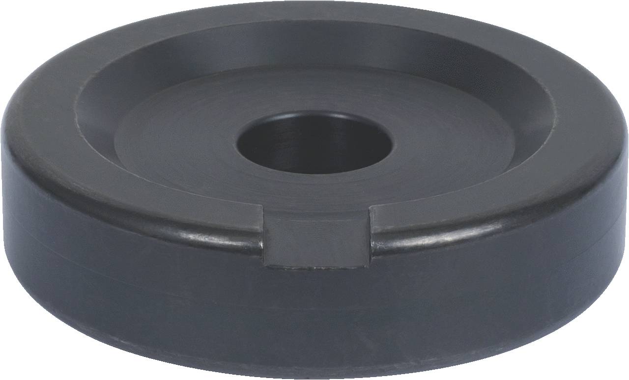 Black metal ring with a central hole and flat groove, possibly a machine component, on a neutral background.