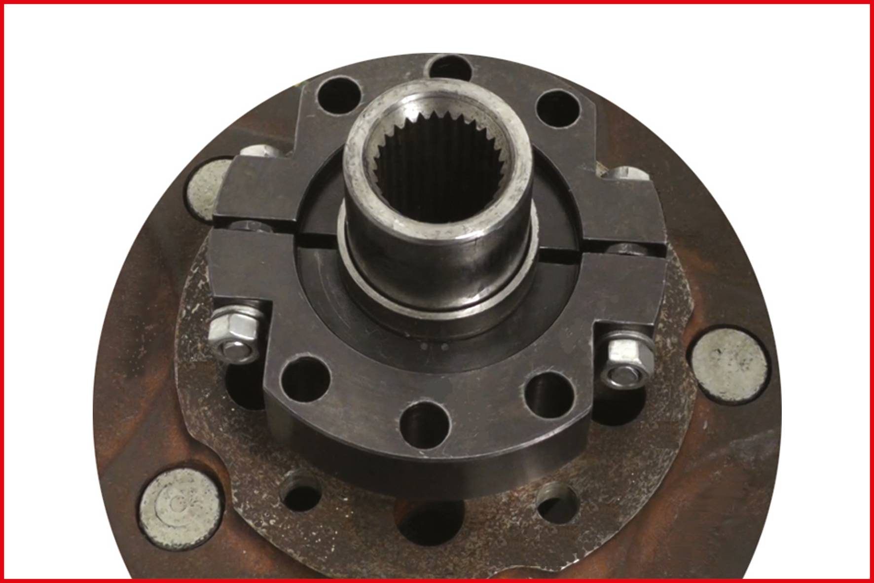 A metal mechanism with circular components, screws and bolts. Primary component of a larger mechanical system.