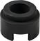 A black, cylindrical metal piece with a large central hole and a slotted base section.
