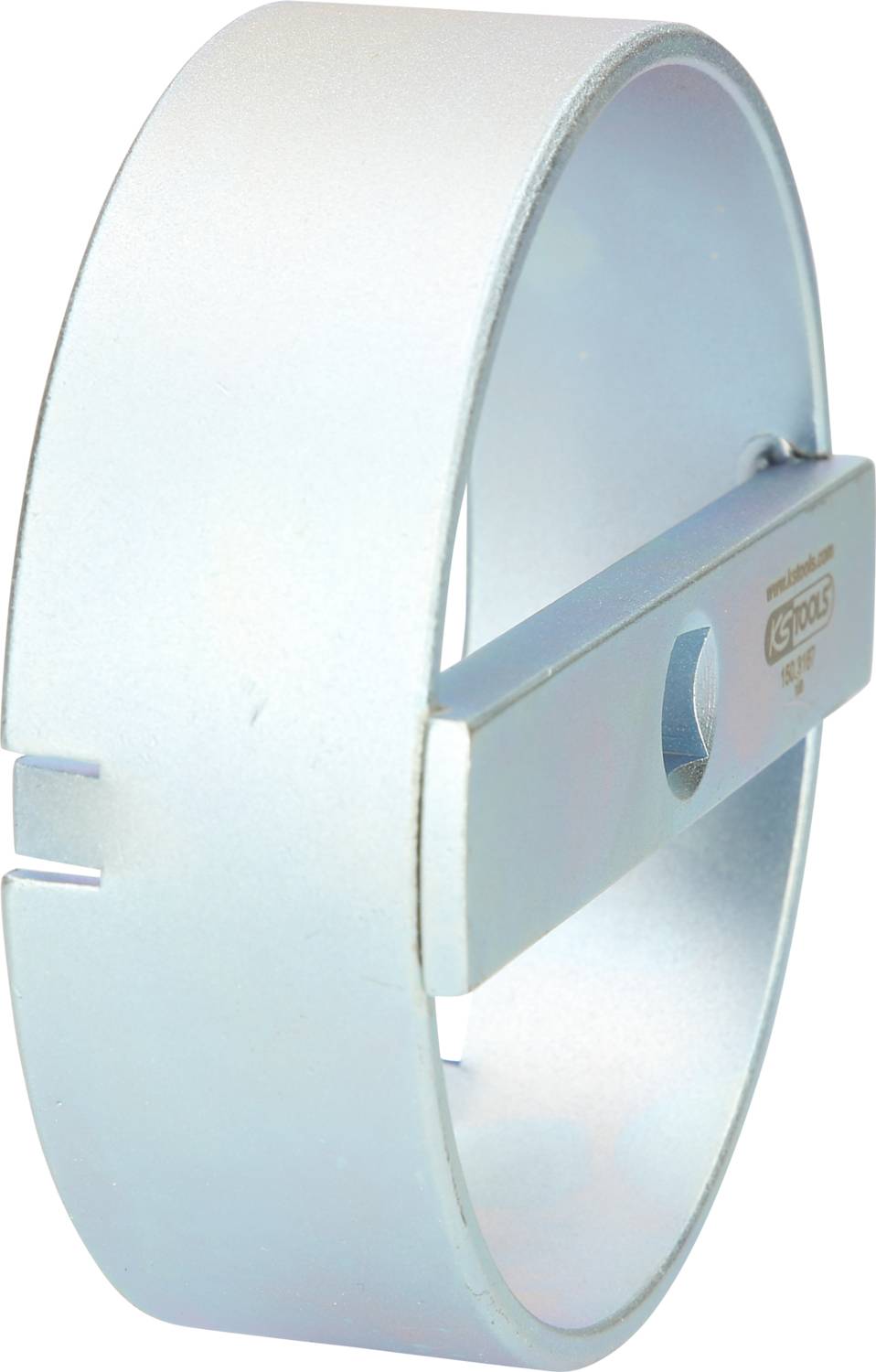 Cylindrical metal tool with a side slot and an attached rectangular piece with inscription; mechanical component.