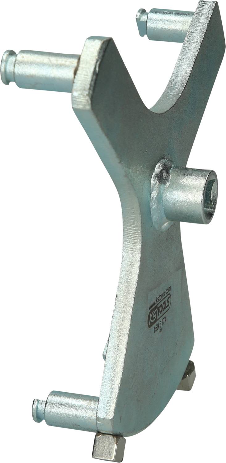 A metallic tool with three bolts of different sizes, used for turning round nuts on vehicle suspensions.