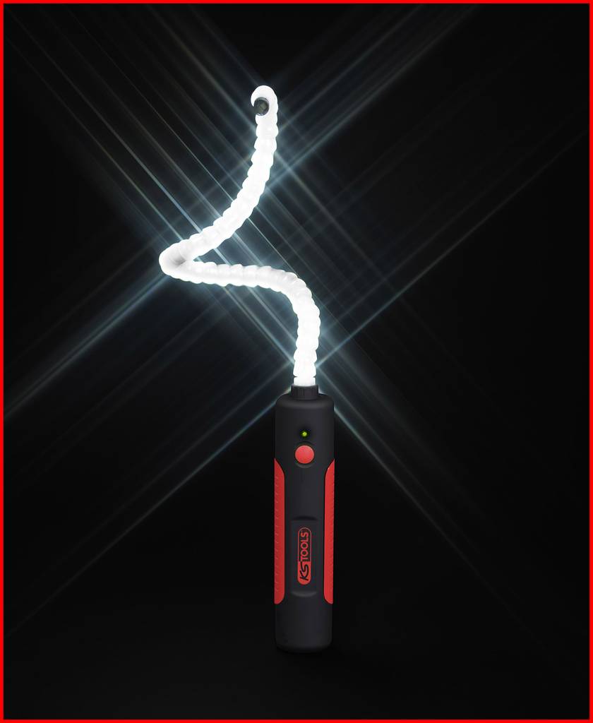 A handy LED tool light with a flexible illumination arm on a black background. The light shines intensely and emphasises its flexibility.
