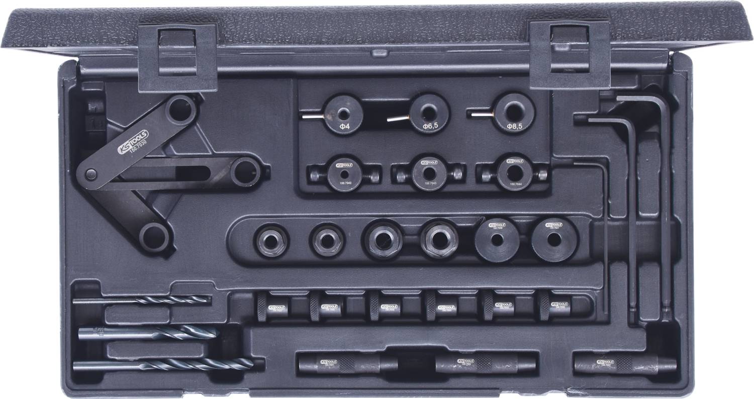 Toolbox with various metal drill bits and accessories, including drill attachments and spanners in a plastic case.