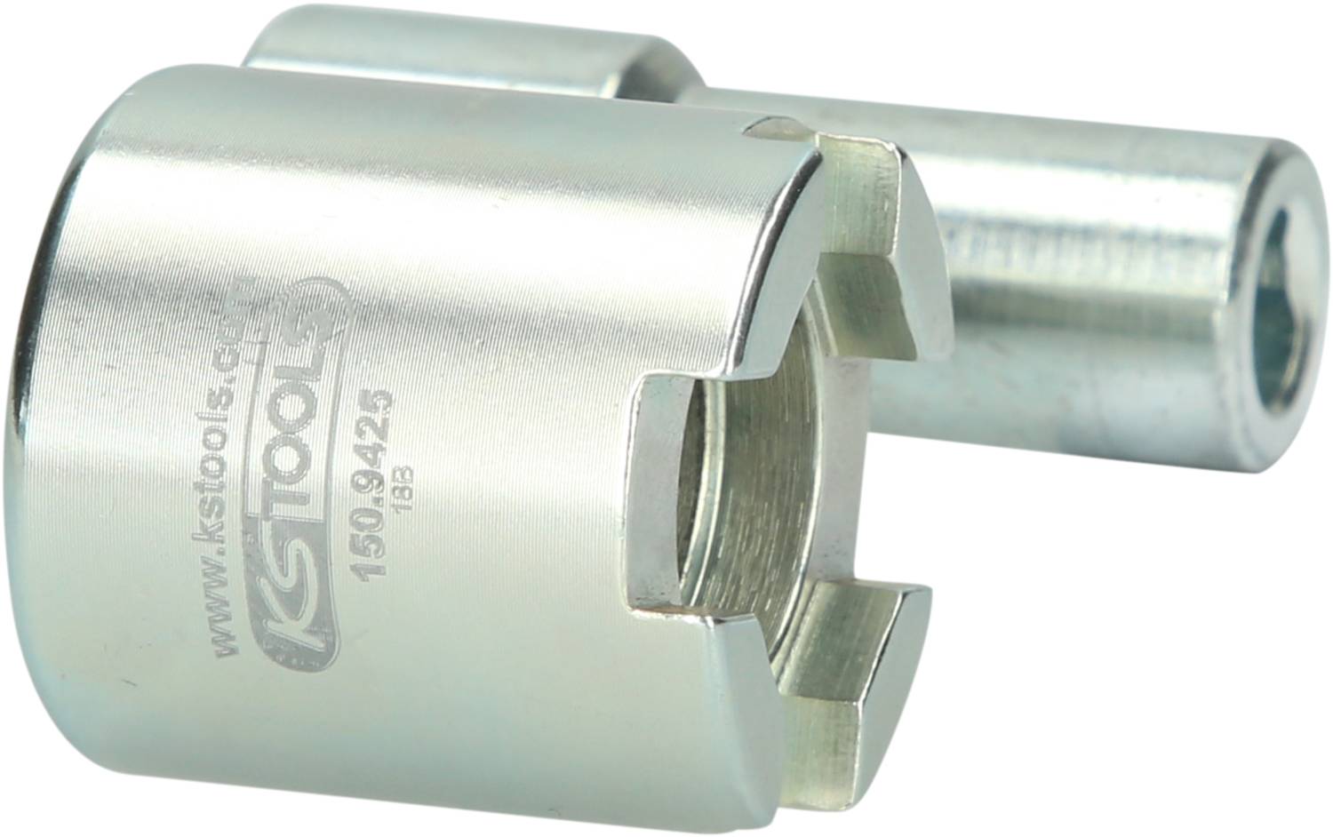 Metal tool with a cylindrical shape and recesses at the opening. Beside the tool is a cylindrical rod.