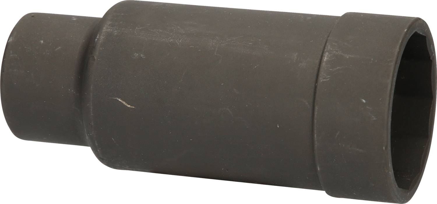 A black, cylindrical metal part lying on a white surface.