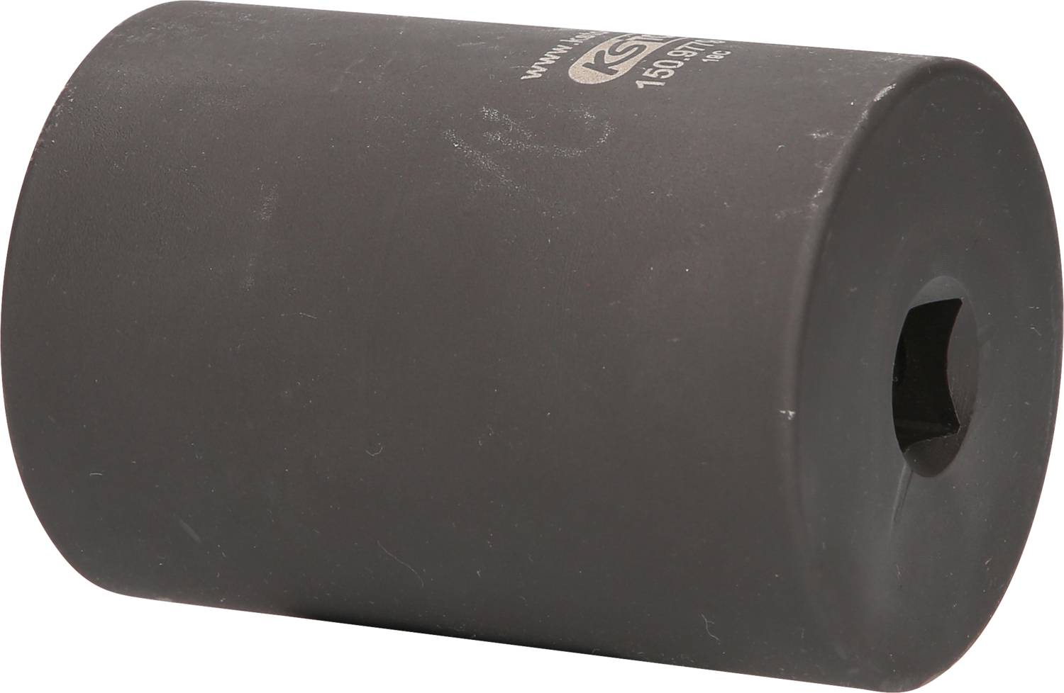 A black, cylindrical adapter with a square hole in the centre. Top surface printed with the inscription 'Kraftwerk'.