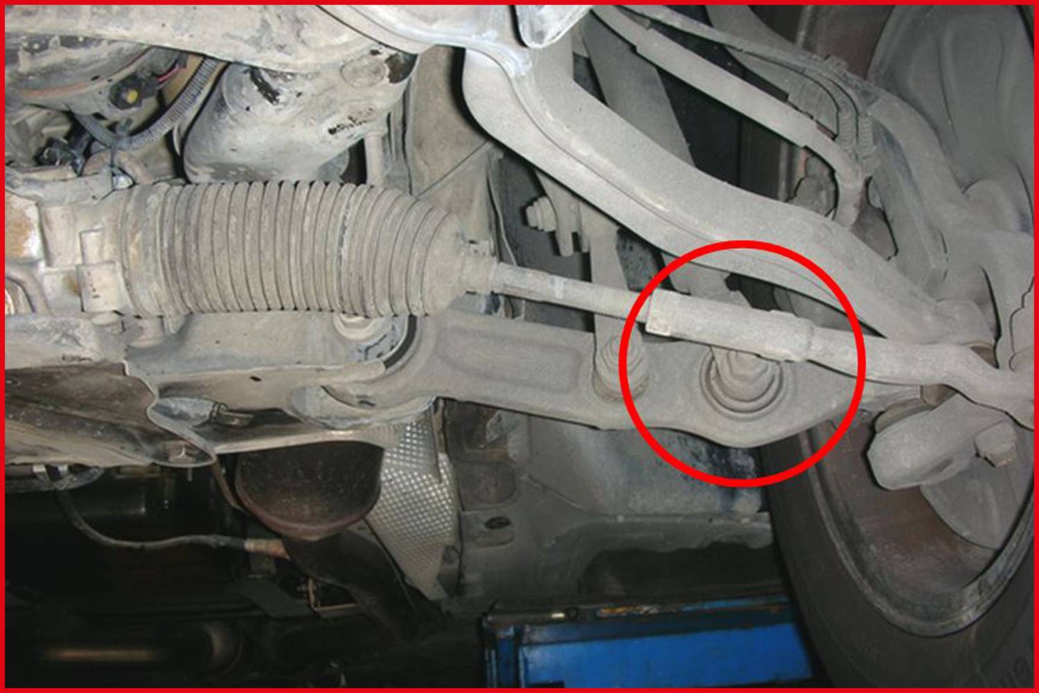 A steering system in a car with a damaged area highlighted within a red circle.