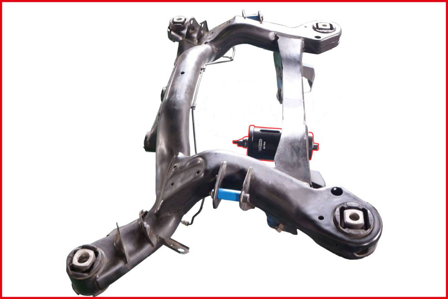 'Metallic car cross-member, rusted, with weld seams and bolts, on a white background. Component of the chassis.'