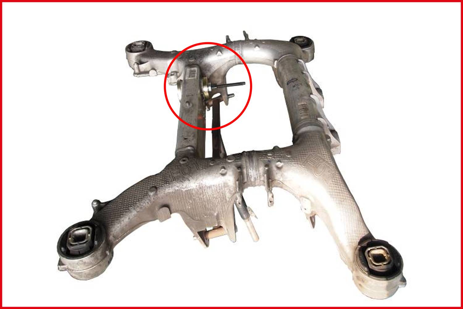 'Vehicle axle carrier made of metal, with a specific component highlighted in the red circle, which is important for stability.'
