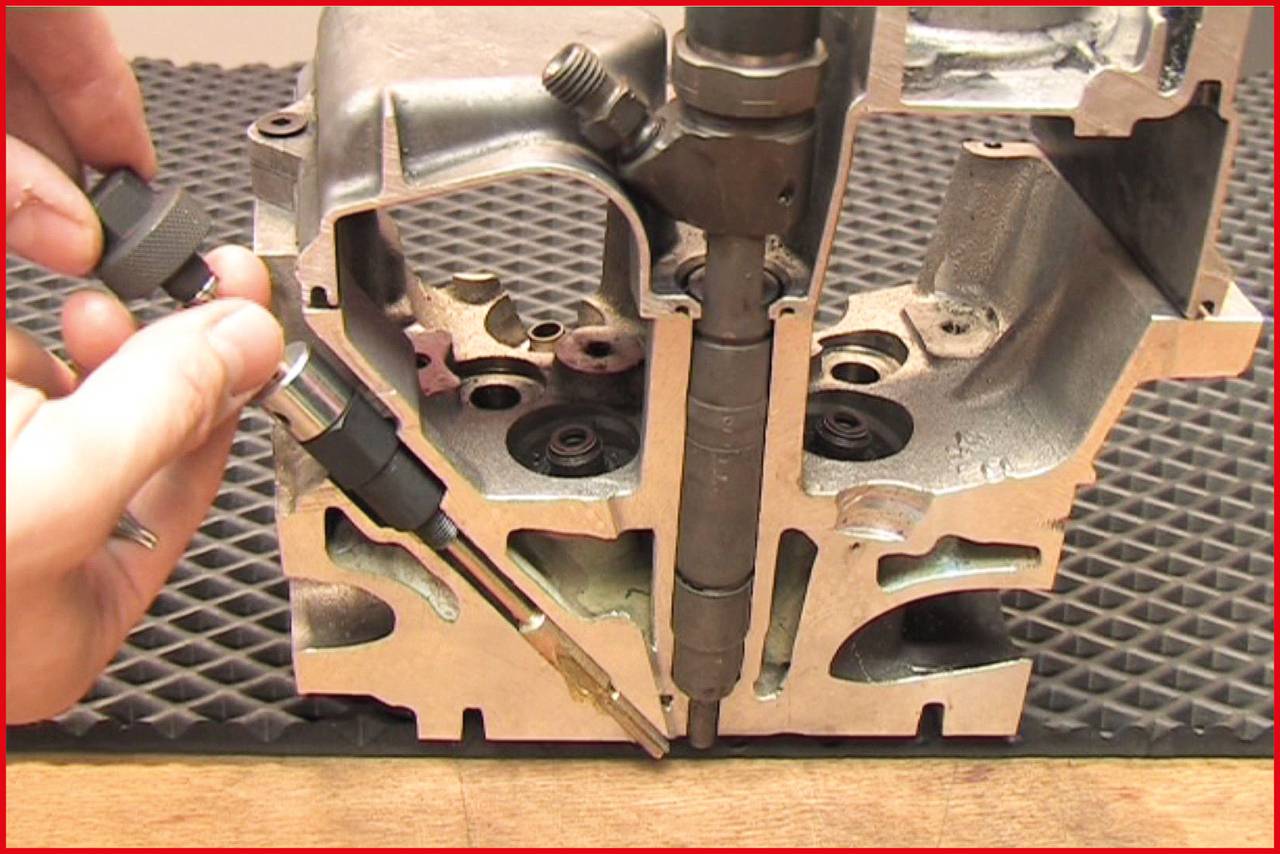 A metal piece with a partially cut-away view reveals the interior of an engine, while a hand works on a screw with a tool.