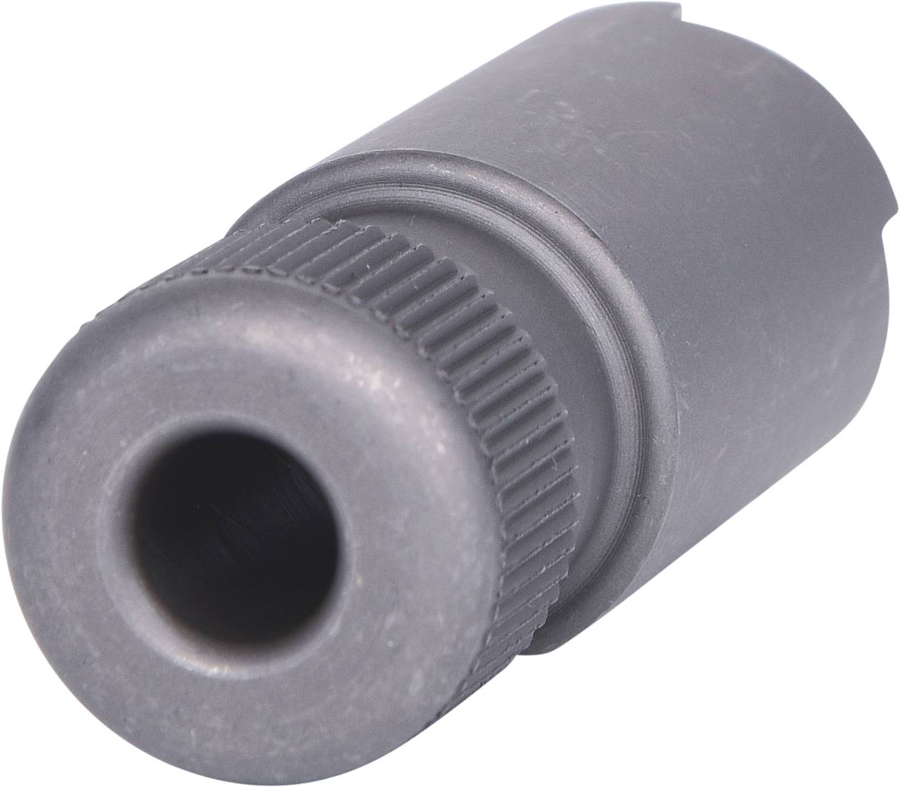 Cylindrical metal object with a ribbed end and a wide opening on the opposite side, potentially a technical component.