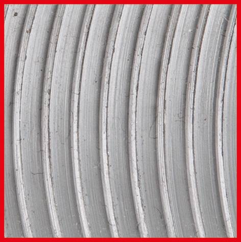 Close-up of several parallel, grey, curved lines on a surface, framed by a red border.