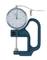A blue measuring instrument with a round dial and scale for measuring thicknesses in millimetres. It is used in technical and craft applications.