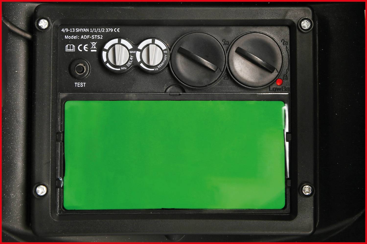 An electronic control panel with three rotary knobs for adjustment, a green indicator, and a test button. Model number visible at the top.