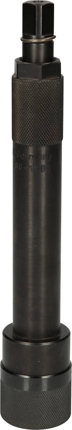 A black cylindrical metal stamp, standing vertically, with a knurled handle and a hexagonal tip.