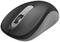 Black, wireless computer mouse with two buttons and a scroll wheel, positioned on a white surface.