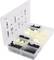A plastic storage box with compartments, filled with black and white fastening clips. The lid displays an overview of the parts.