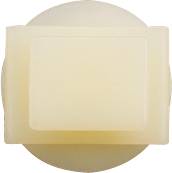 A rectangular, ivory-coloured piece of soap with a smooth surface, placed on a round base.