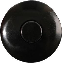 A round, black button with a raised centre, possibly a doorbell button or a switch.
