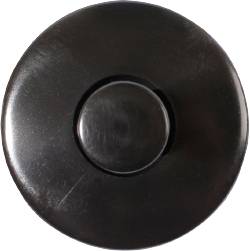 Black, round doorbell button, centrally positioned in the image, on a white background.