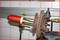 A tool shows the removal of a ball joint from a vehicle wheel carrier. The ball joint is partially rusty and secured.