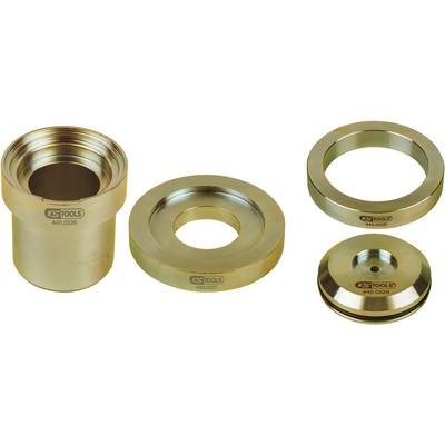Four gold-coloured metal parts, presumably tool attachments, arranged: on the left a hollow cylinder, beside it three differently shaped discs.