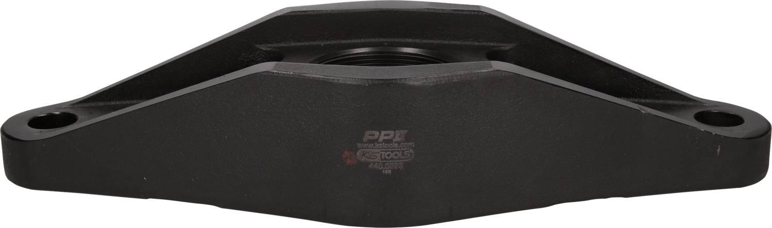 A black machine component with two holes at its ends; it could be part of a larger machine.