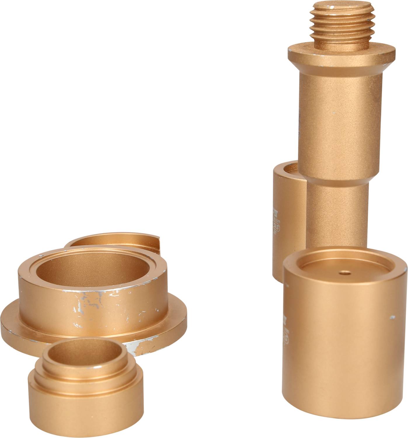 Two golden metal components with cylindrical shapes, partially damaged. The left-hand piece consists of three interlocking sections, whilst the right-hand piece comprises two longer stacked parts with threading at the top.