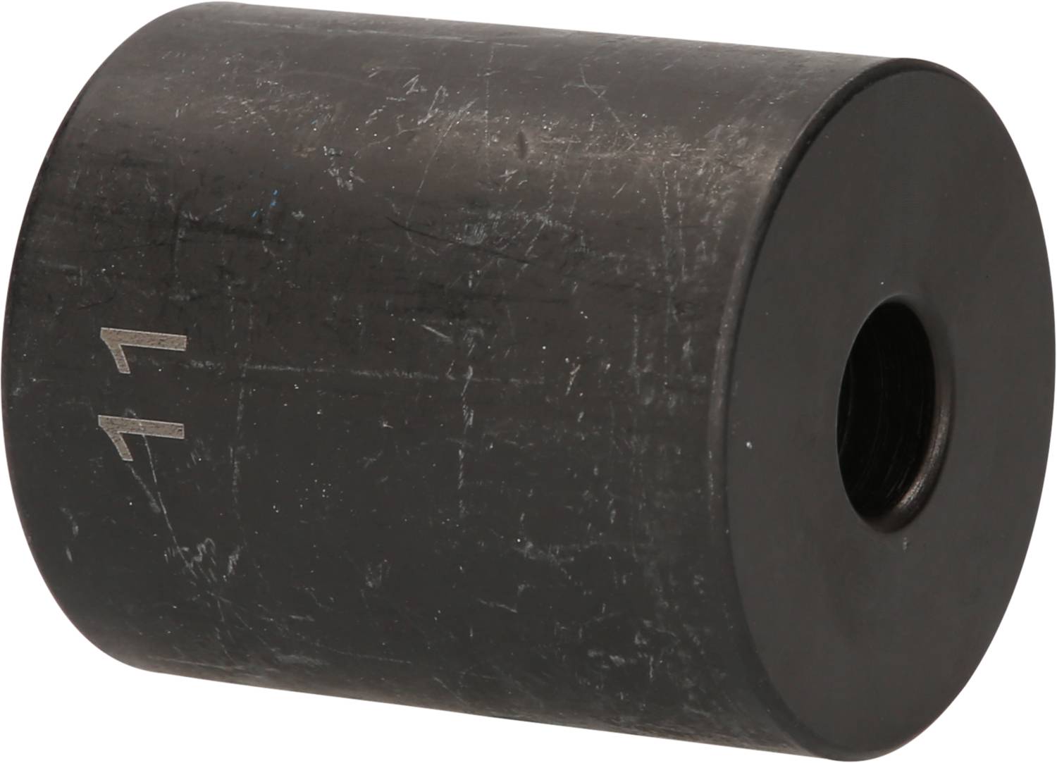 A black, cylindrical magnet with a central bore. The surface is slightly scratched and the number '11' is visible on it.