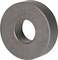 A round metal magnet with a hole in the centre, rests on a neutral surface. The magnet has a uniform, grey colouration.