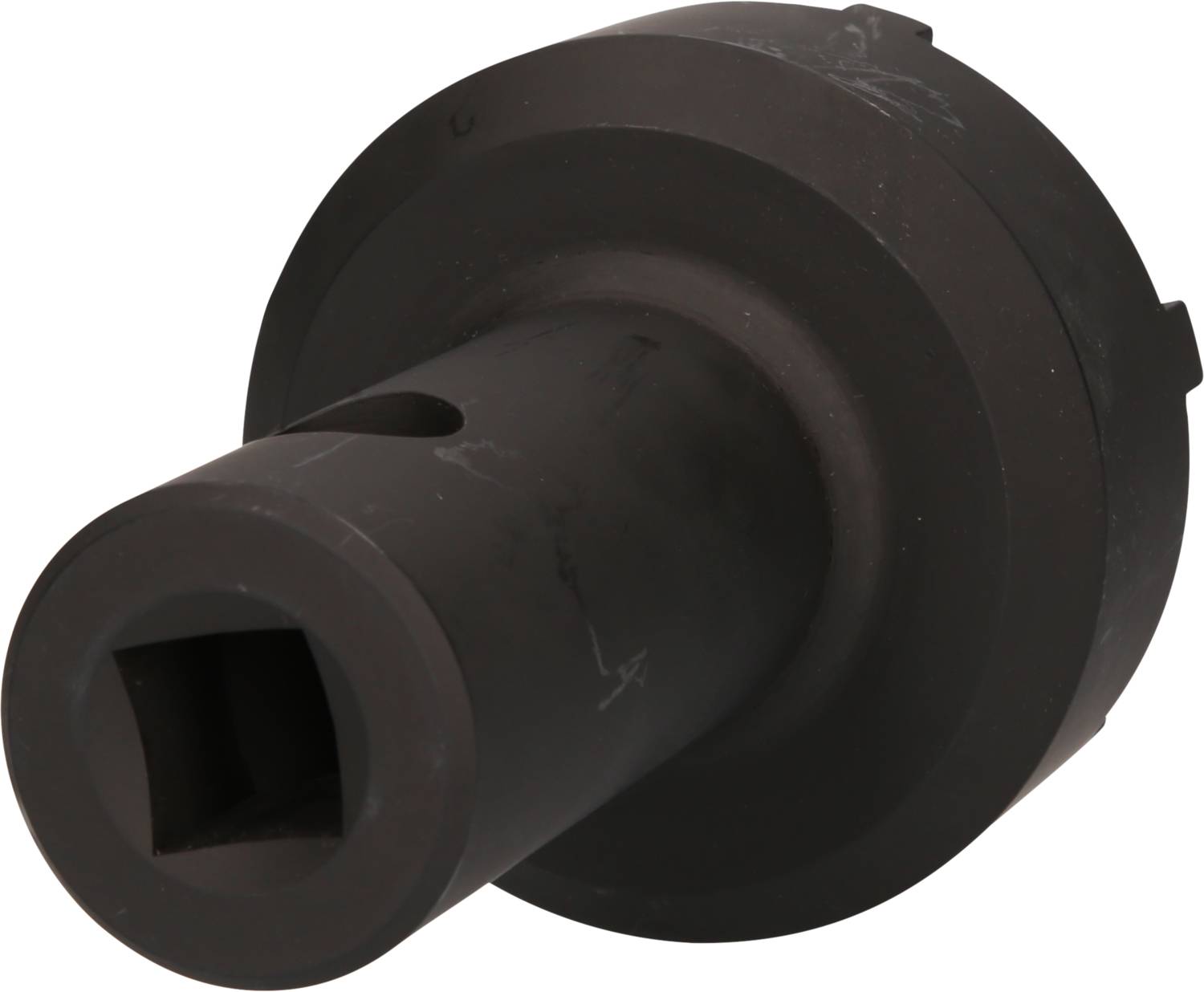 Black metal tool, cylindrical with a square opening, possibly for mechanical applications or mechanical engineering.