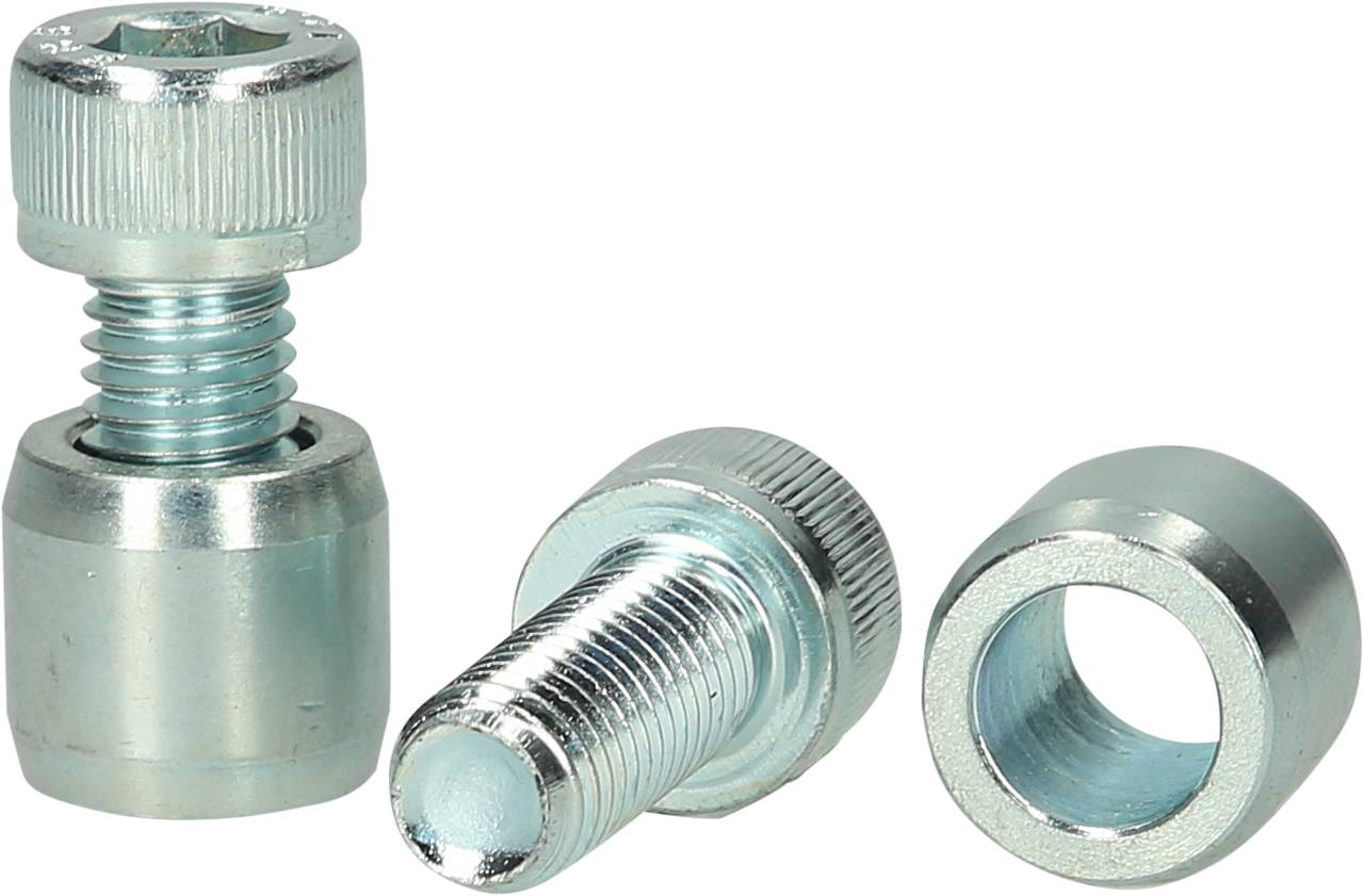 Three silver screws and sleeves are lying on a surface. One screw is standing upright, while the others are lying down.