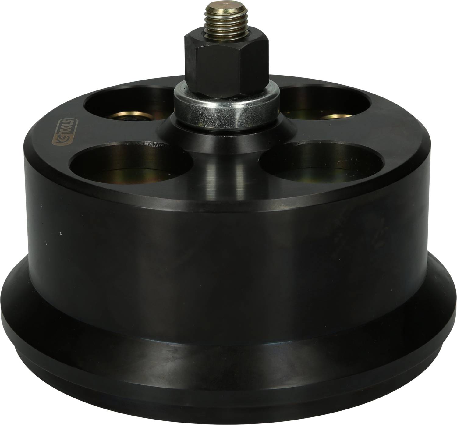 A black, circular machine component with multiple holes and a central screw at the top. Used in technical applications.