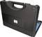 Black hard-shell suitcase with handle and rounded corners, slightly open, containing a blue tool set.