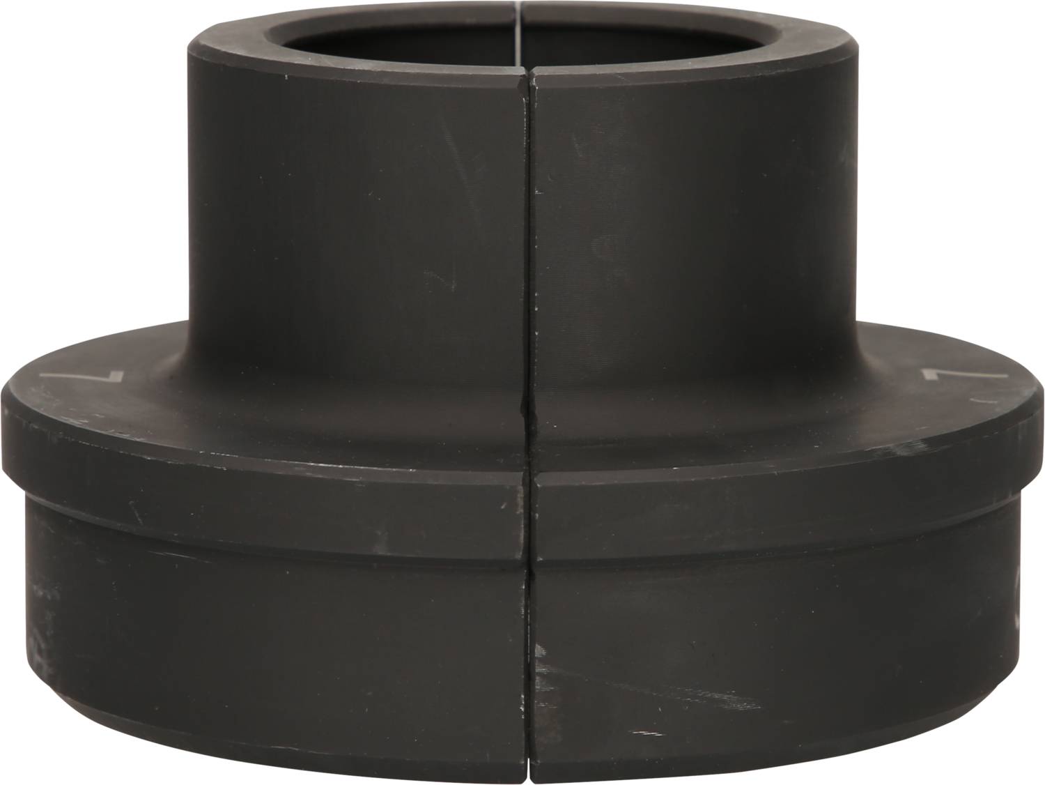 A black, cylindrical machine component with a smooth surface and visible separation lines in the middle.