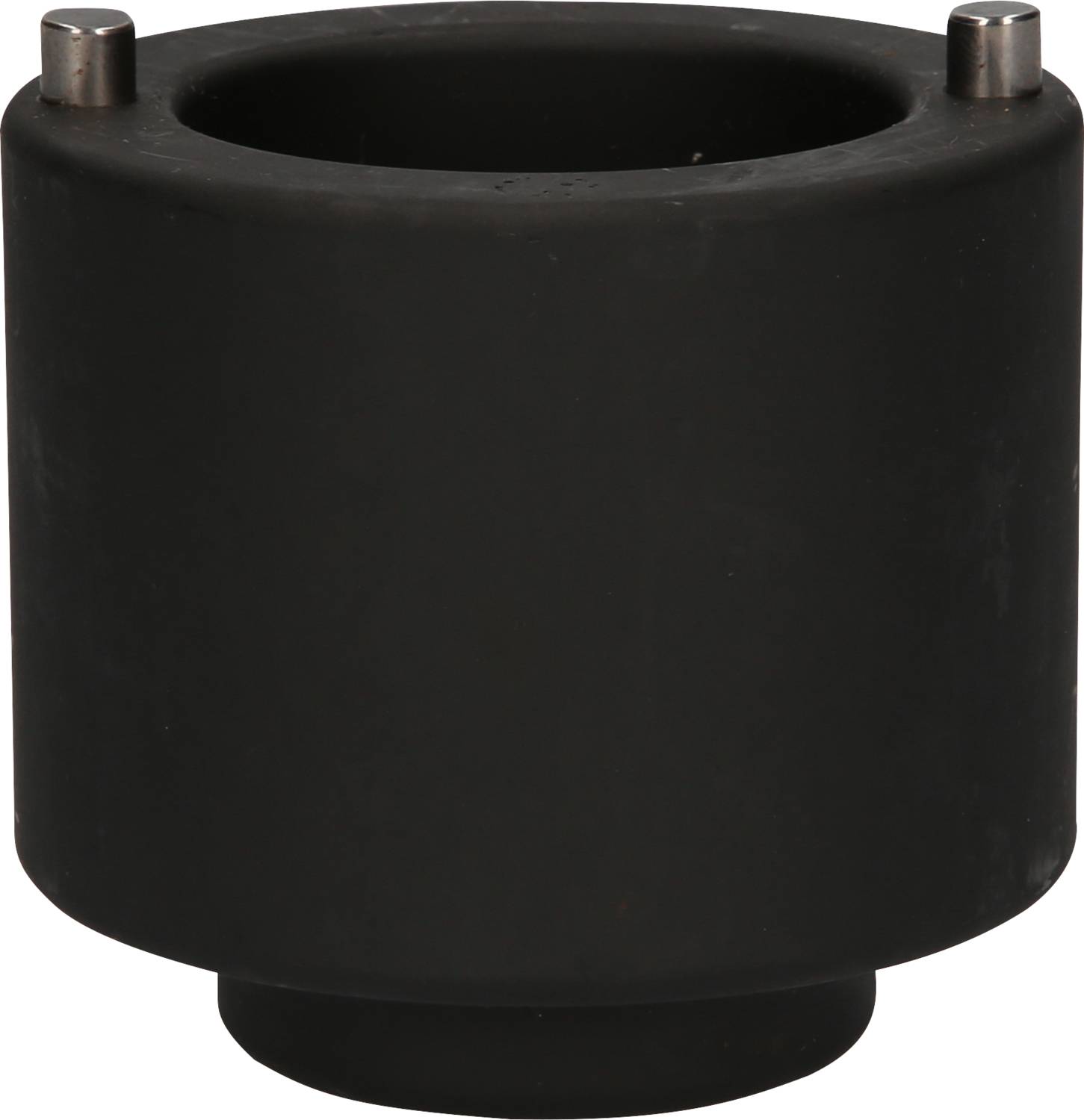 A black, cylindrical object with two small metal pins on the top surface, possibly a technical component.