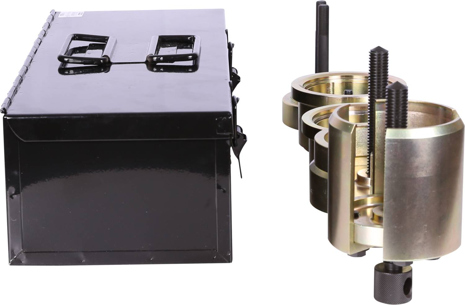 A black metal box next to a set of metallic tools with screw threads and rings, likely for mechanical applications.