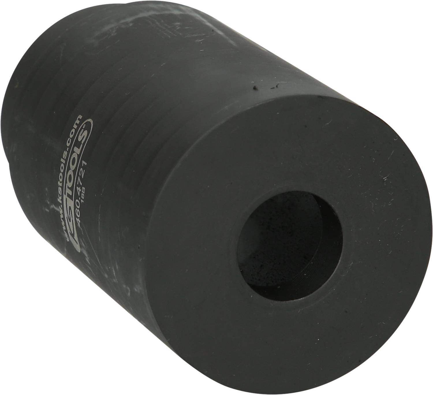 A black cylindrical rubber buffer with a hole in the centre, used for shock absorption.