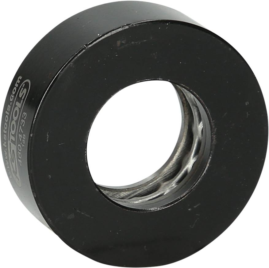 Black cylindrical bearing with visible balls in the centre, used to reduce friction in mechanical applications.