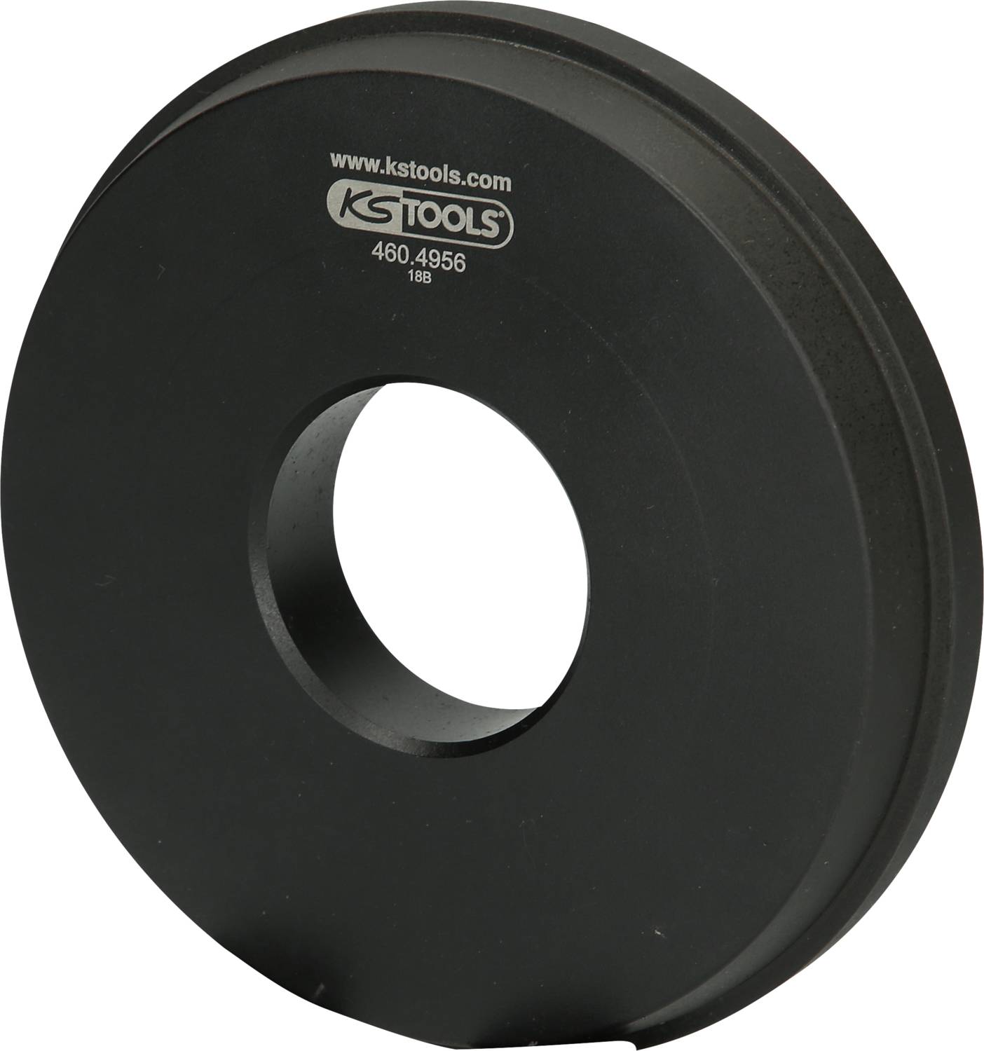 A black, round metal disc with a hole in the centre, inscribed with 'KS TOOLS' and a serial number.