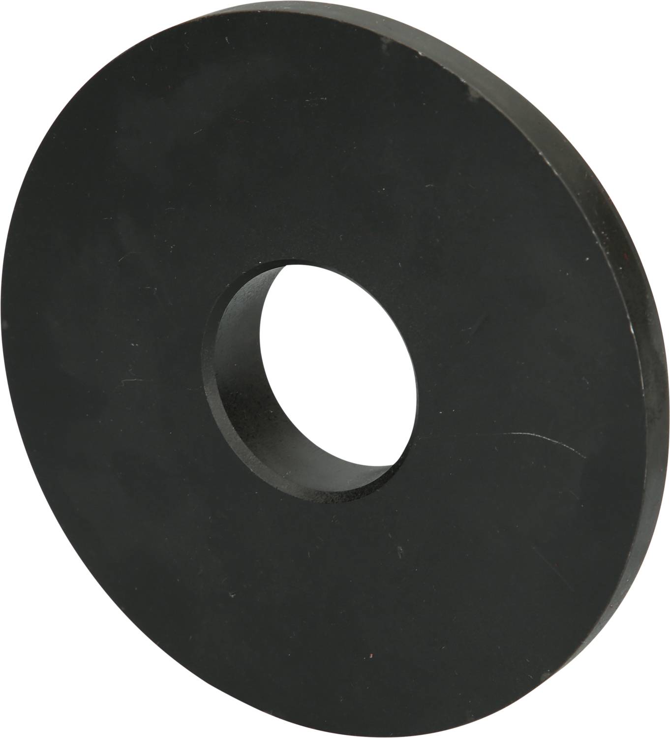 Round, black metal washer with a hole in the centre, on a grey background.