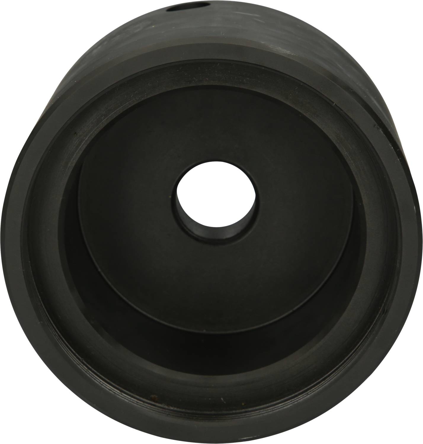 A black, cylindrical object with a hole in the centre, viewed from above.