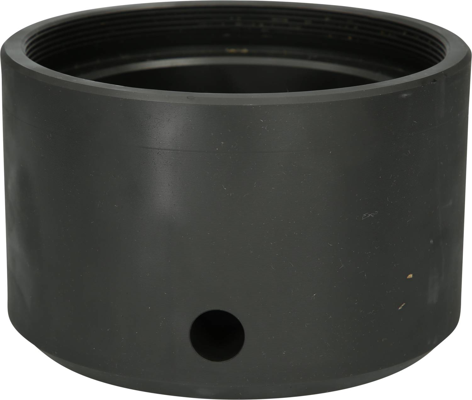 A cylindrical metal piece with a small hole on its side and a larger open end. It appears functional and robust.