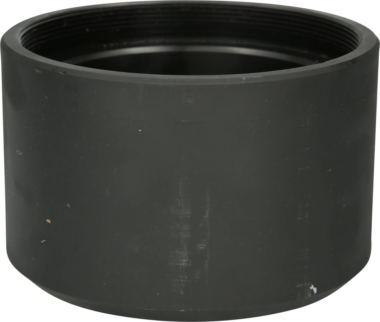 A black, empty, cylindrical plastic container, possibly a cap or protective part for a larger piping system.