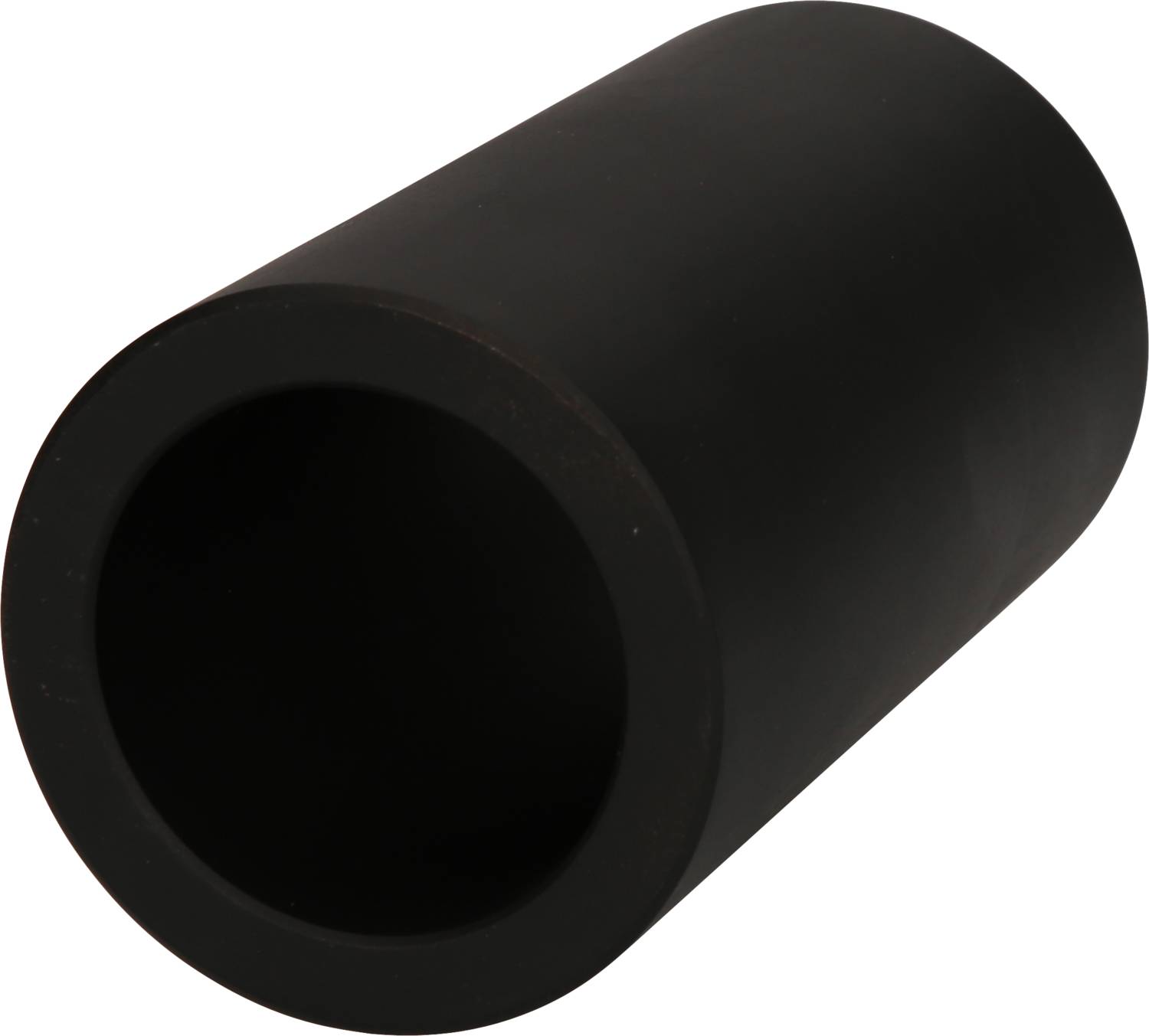 A black, hollow cylinder lies at an angle on a surface.