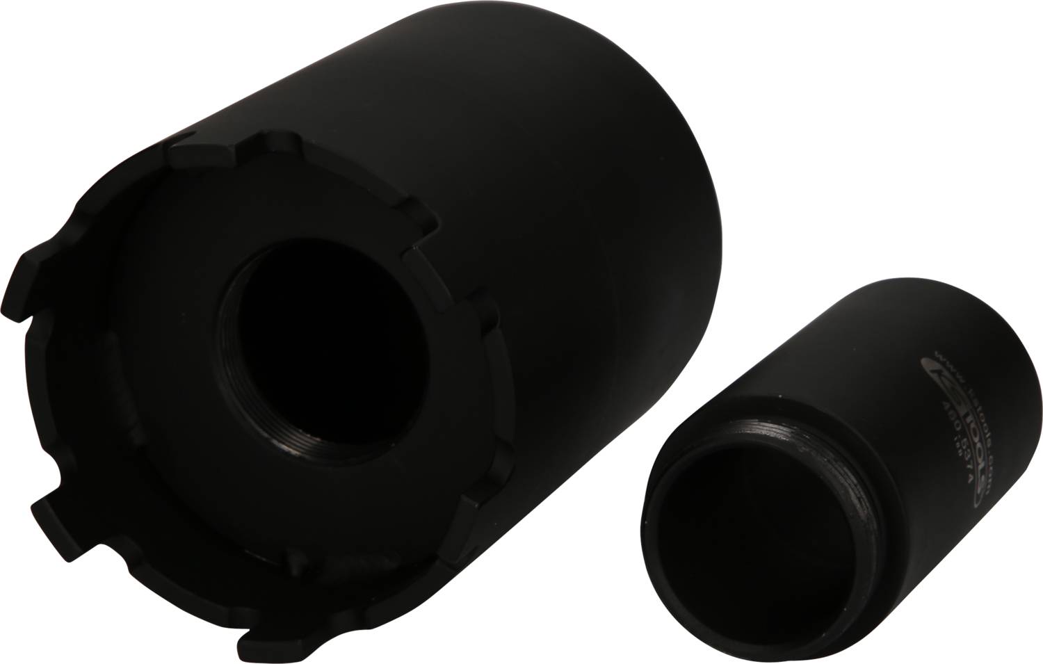 Two black metal cylinders, one large and one smaller, side by side on a white surface. They appear to be of a technical nature.