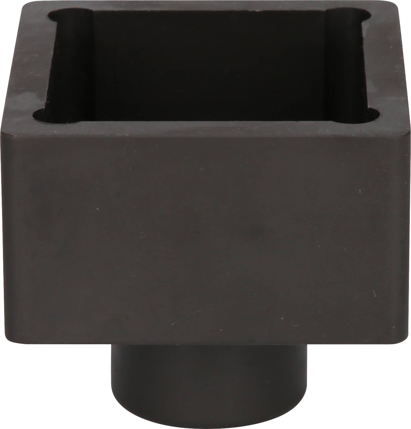 A black, rectangular plastic container with rounded corners and a round base can be seen.