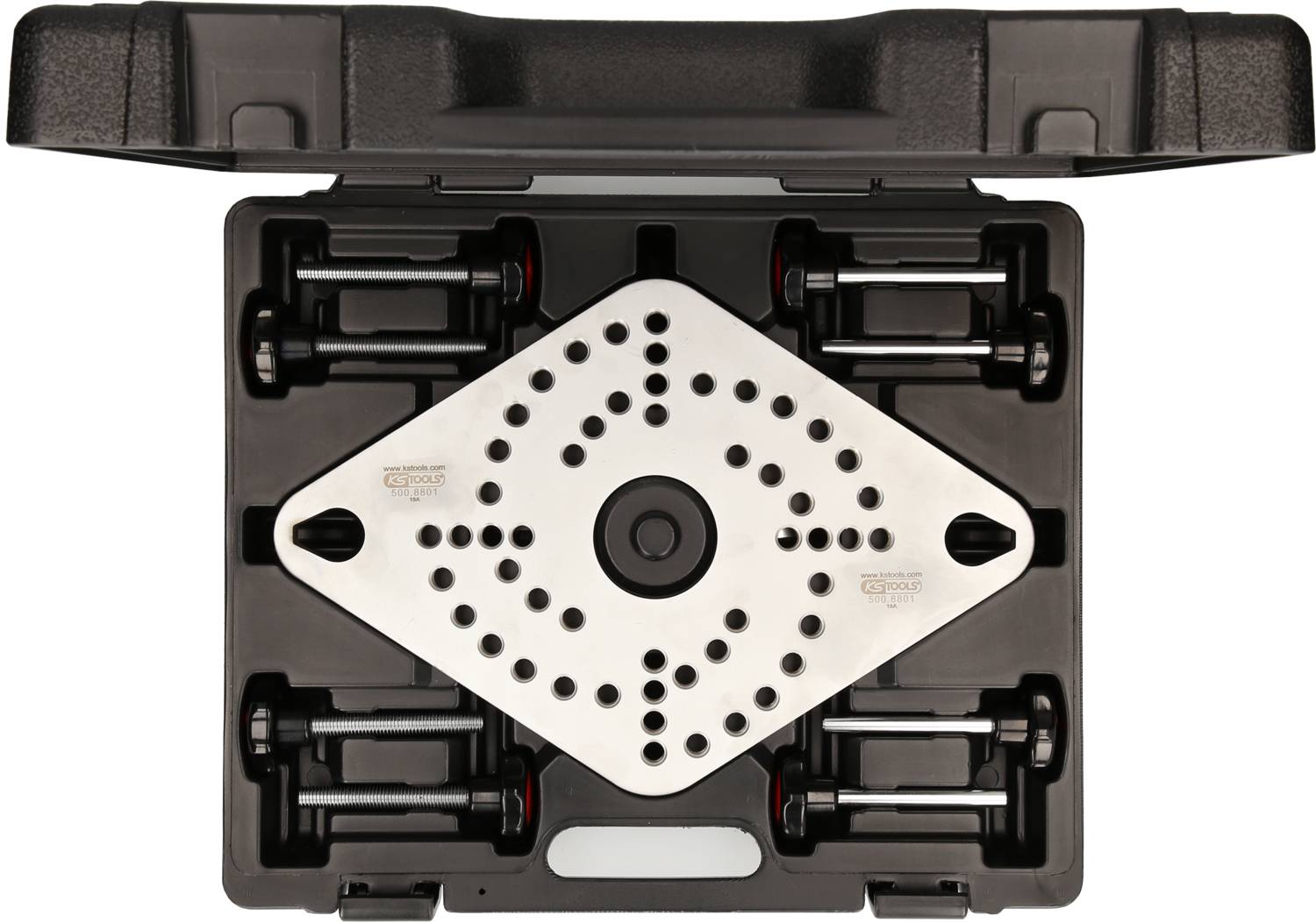 A black suitcase with an open lid contains a shiny, perforated metal component in the centre, surrounded by black brackets.